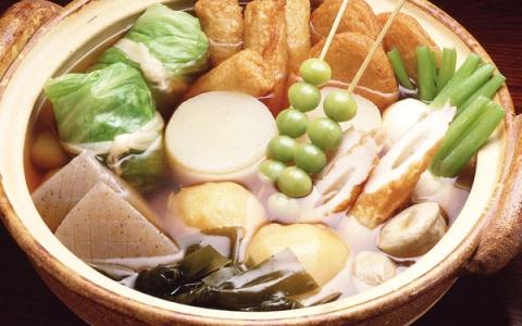 Chanko nabe hot pot with tofu, vegetables, chicken, and broth in earthenware bowl
