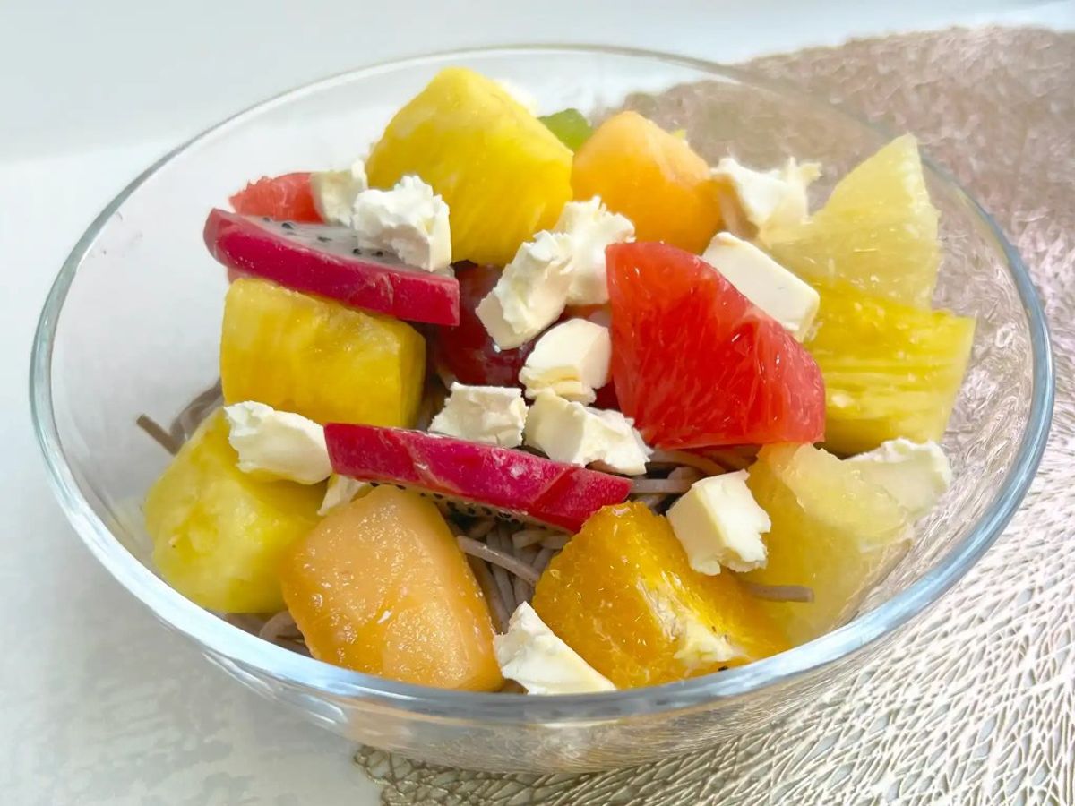 Colorful citrus salad with grapefruit, feta cheese, and beetroot in glass bowl