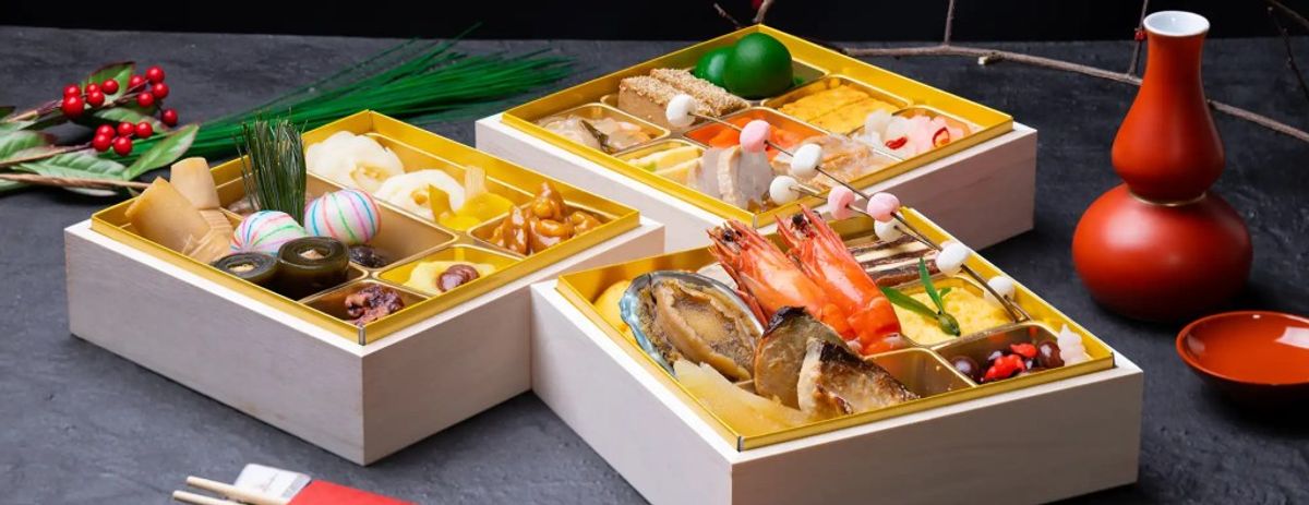 Luxury bento boxes with sashimi, seafood, vegetables, and traditional Japanese ingredients displayed elegantly