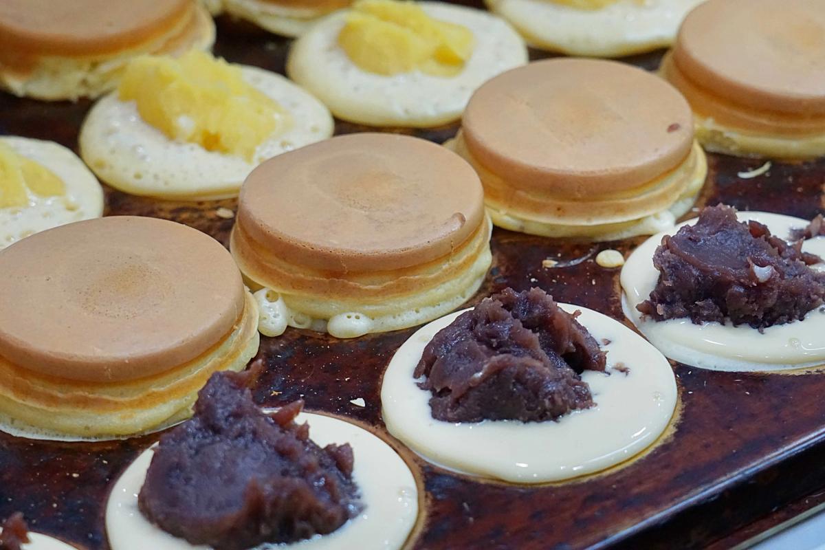 Assorted French pastries including foie gras, chocolate mousse, and lemon tarts on display