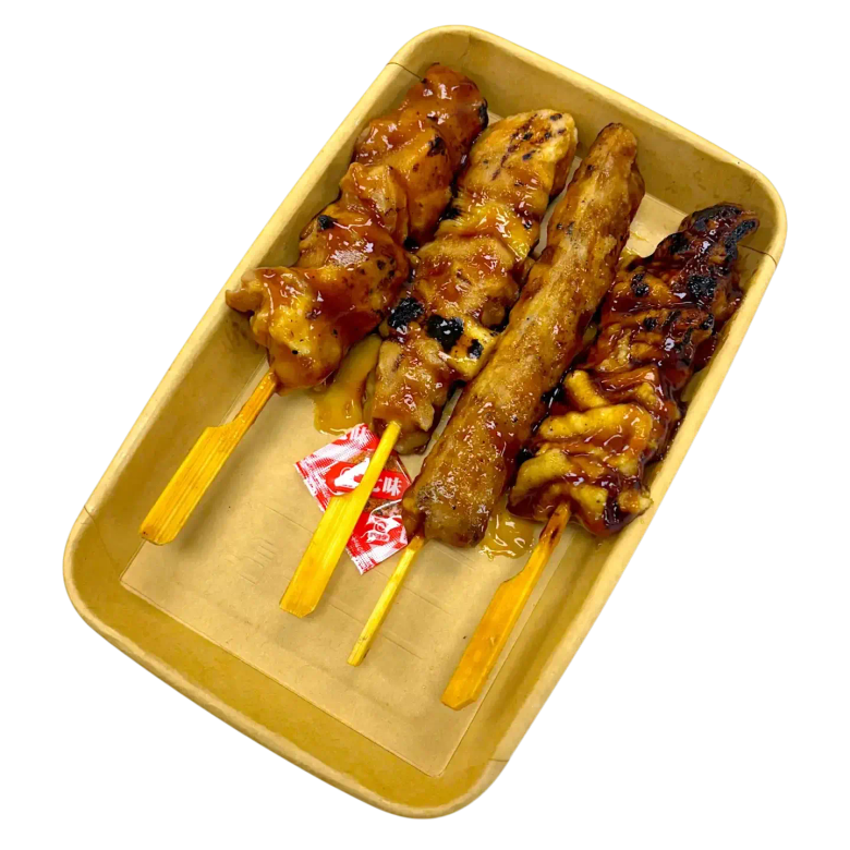 Grilled chicken skewers with caramelized glaze on wooden sticks in yellow tray