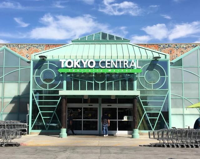 Tokyo Central grocery store entrance with mint green Art Deco facade and large speaker designs