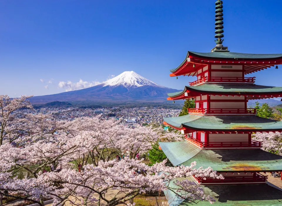 Mount Fuji with cherry blossoms and red Japanese pagoda in spring landscape