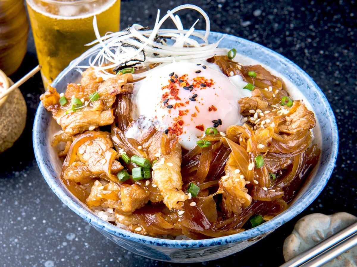 Donburi bowl with tempura, raw egg, scallions, spicy chili flakes, beer