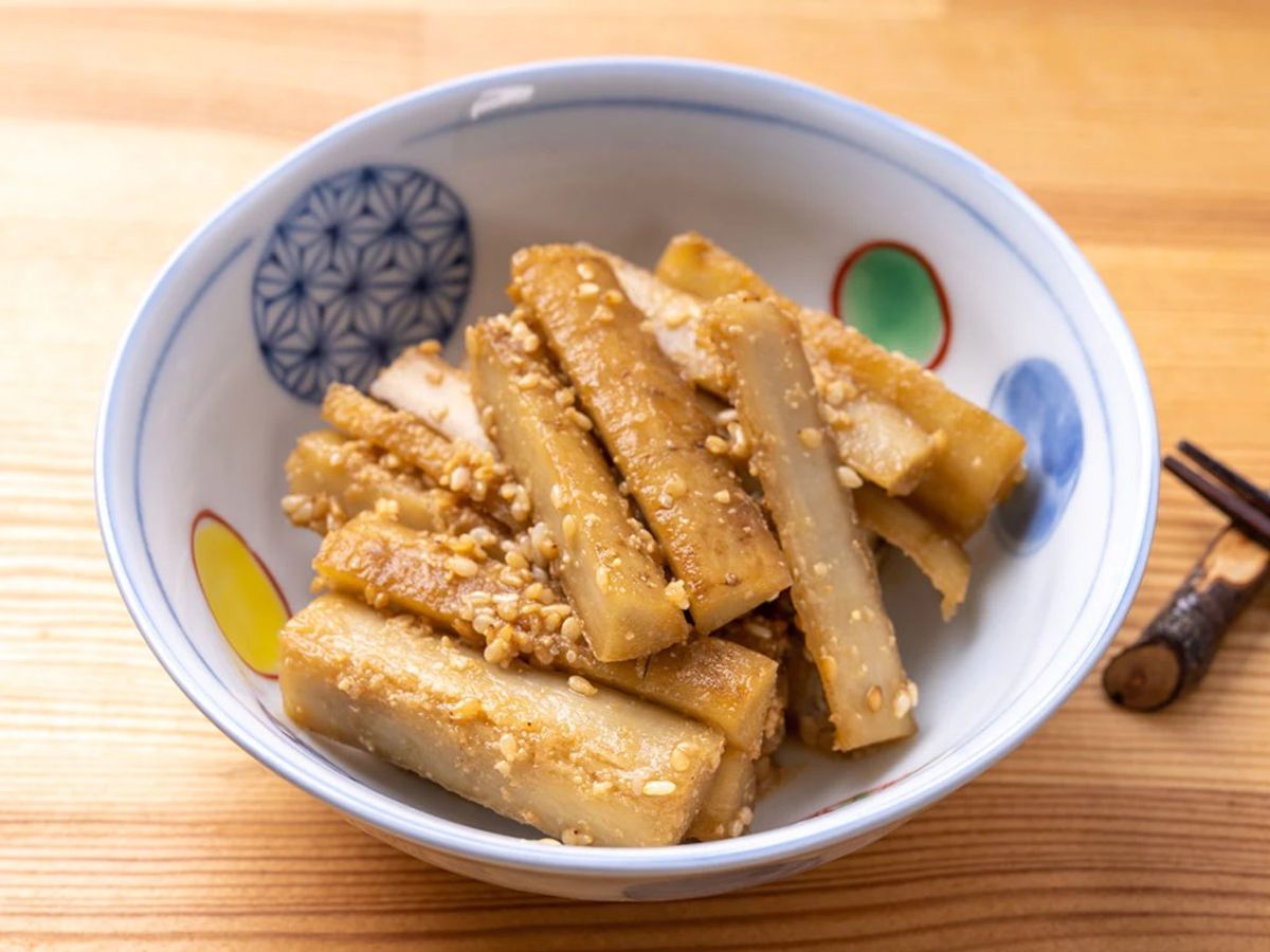 Agedashi tofu served in decorative Japanese bowl with sesame seeds and chopsticks