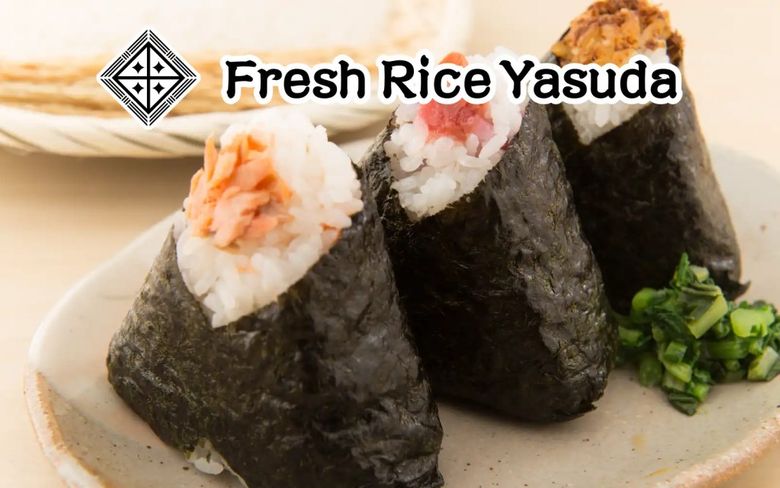 Fresh Rice Yasuda sushi hand rolls with nori, rice, and seafood toppings on ceramic plate