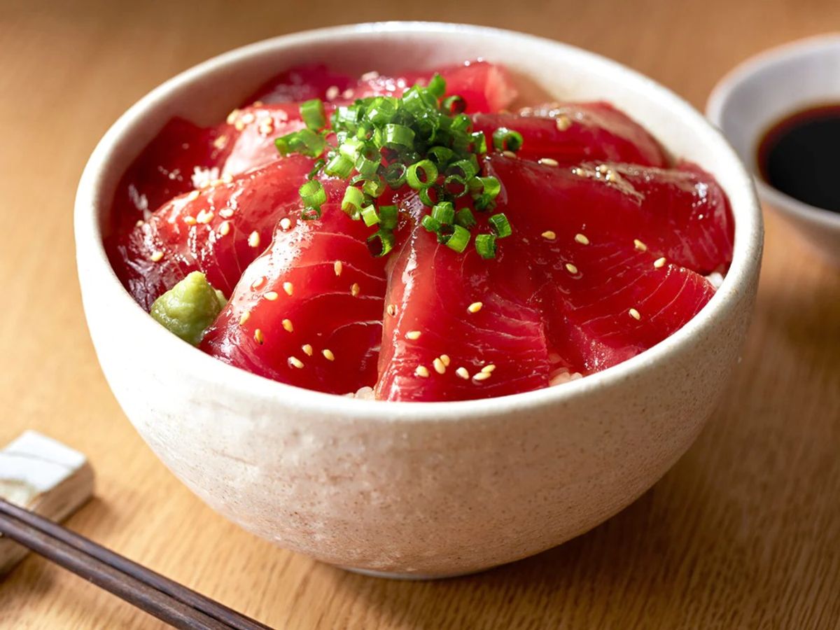 Raw tuna sashimi bowl with sesame seeds, green onions, and soy sauce