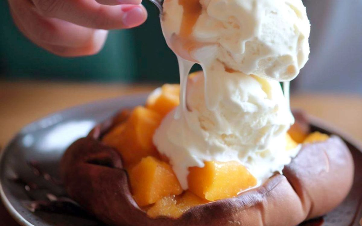 Vanilla ice cream melting on warm chocolate cake with peach compote
