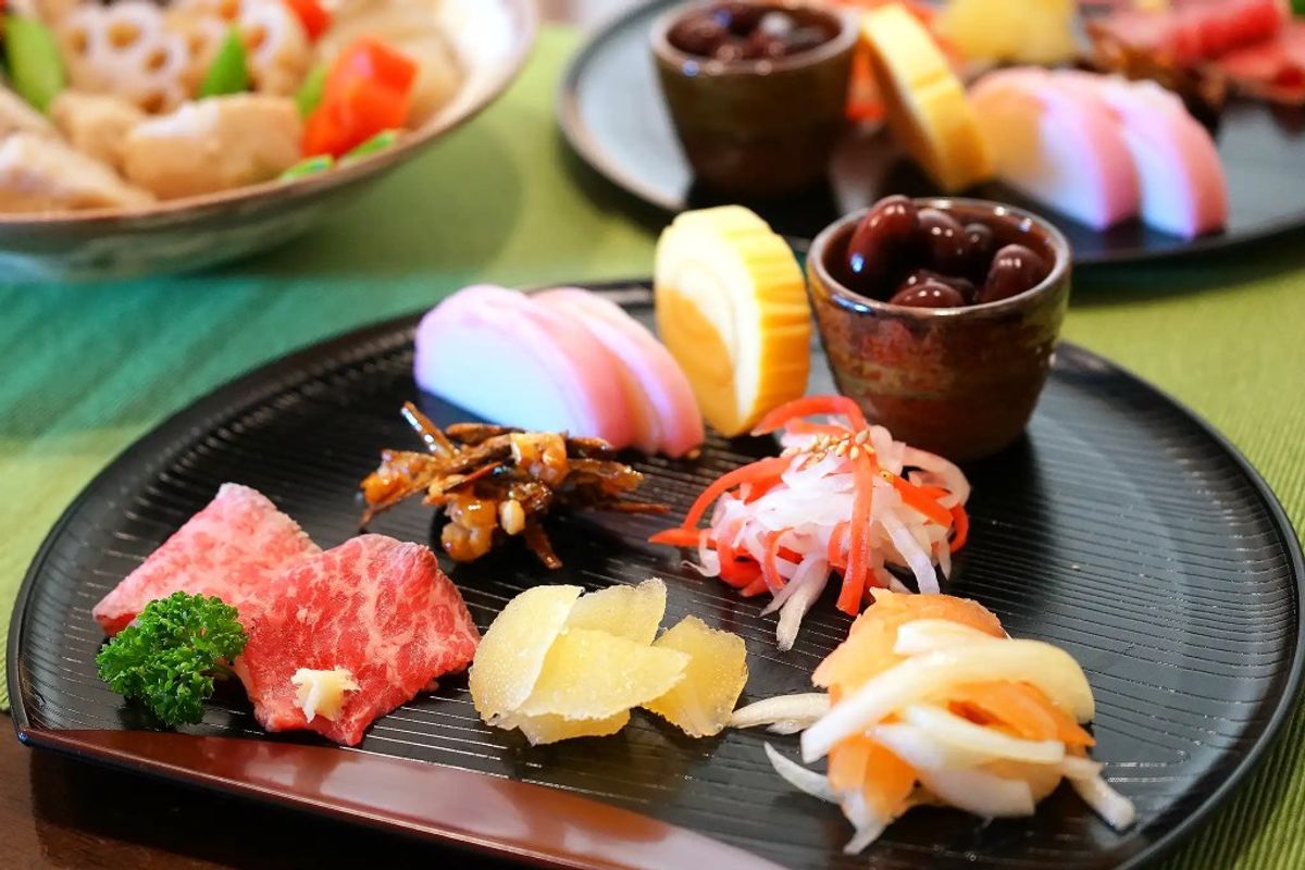 Japanese sushi and sashimi platter with colorful pickled ginger, wasabi, and soy sauce