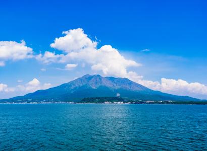 Sakurajima volcano viewed across blue ocean from Kinko Bay, Kagoshima Prefecture Japan