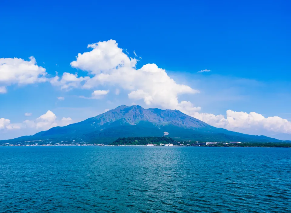Sakurajima volcano viewed across blue ocean from Kinko Bay, Kagoshima Prefecture Japan