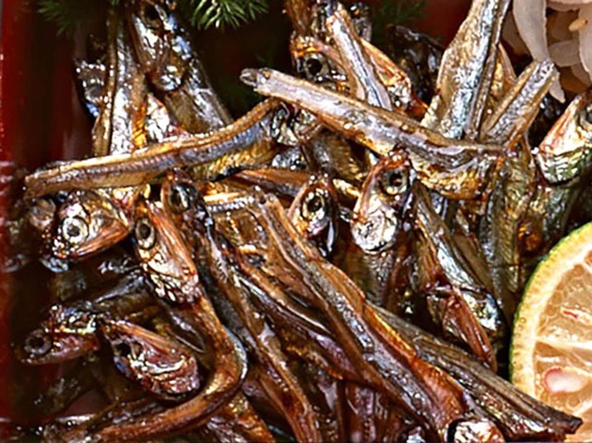 Dried fish and seafood garnished with gold leaf and citrus slices