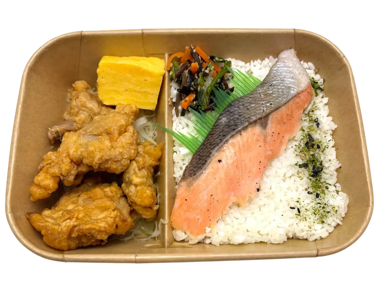 Bento box with fried chicken, salmon fillet, rice, tamagoyaki, and vegetables