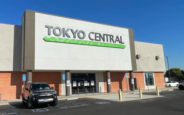 Tokyo Central specialty market storefront with red brick base and white signage under blue sky