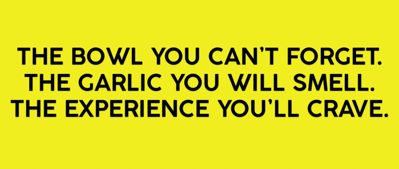 Yellow promotional banner advertising memorable bowl with garlic aroma and craveable dining experience
