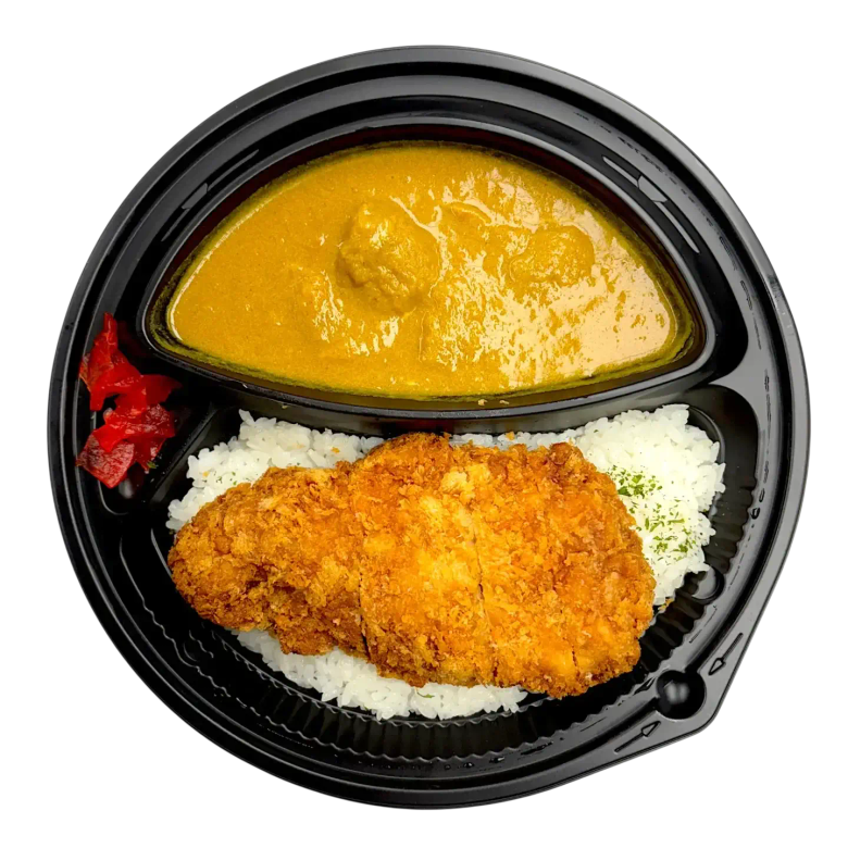Bento box with breaded cutlet, white rice, curry sauce, and pickled ginger