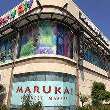 Marukai Japanese Market storefront with curved glass windows and colorful signage