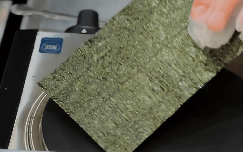 Nori seaweed sheet being held near JSM device for quality inspection