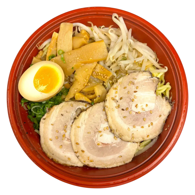 Ramen bowl with sliced chashu pork, soft-boiled egg, bamboo shoots, bean sprouts, and green onions
