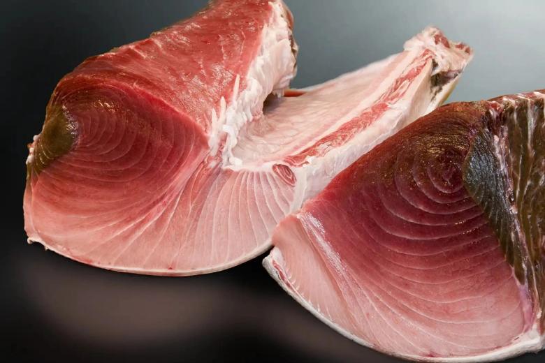 Fresh tuna steaks, cross-section showing raw pink flesh and concentric muscle rings