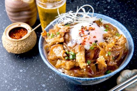 Tempura shrimp and vegetables in decorative bowl with steam rising