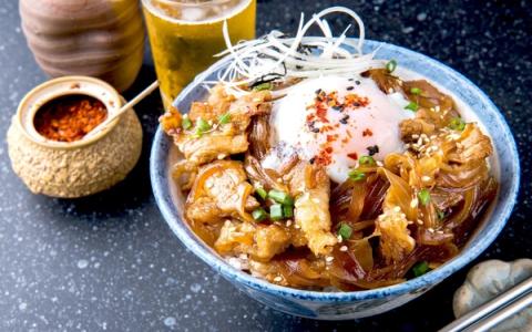 Tempura shrimp and vegetables in decorative bowl with steam rising