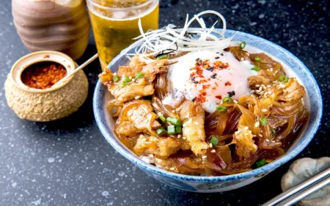 Tempura shrimp and vegetables in decorative bowl with steam rising