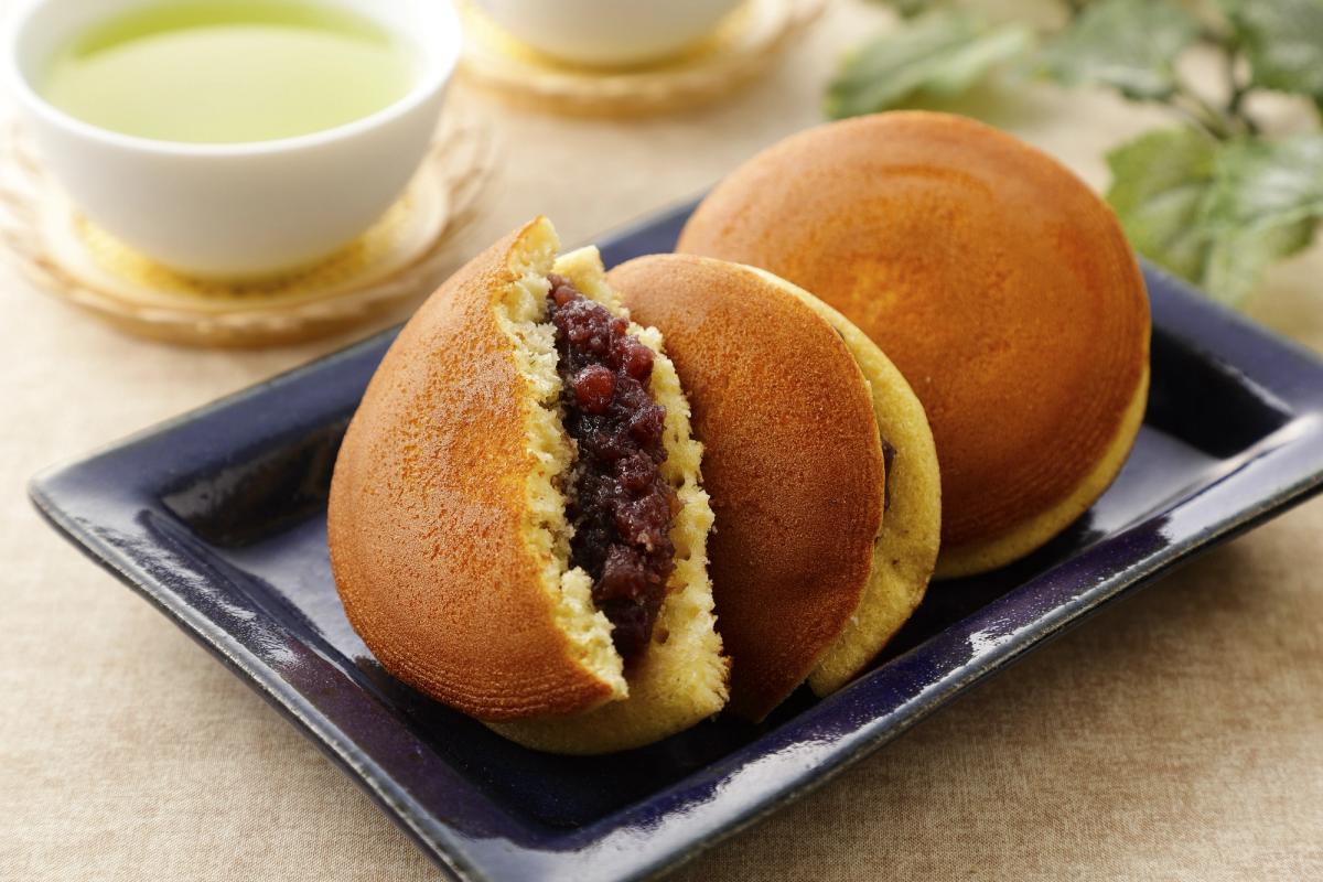 Dorayaki red bean pastries on dark plate with green tea