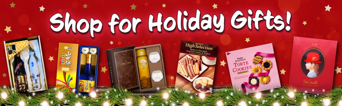 Holiday gift sets display on red background with festive decorations and string lights