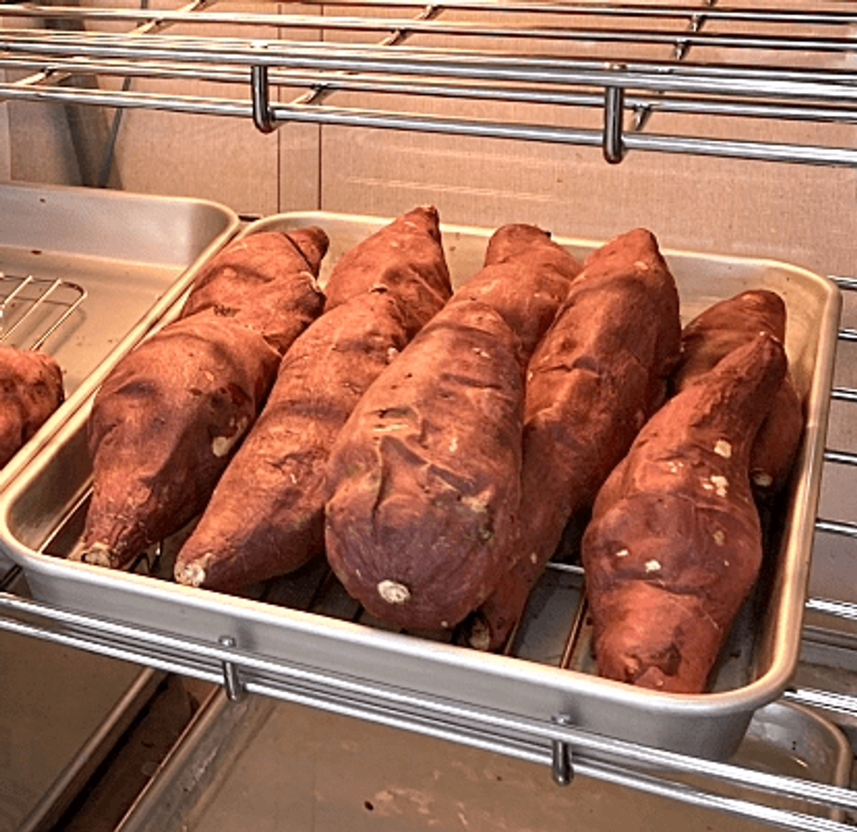 Sweet potatoes in white tray on bakery shelf display