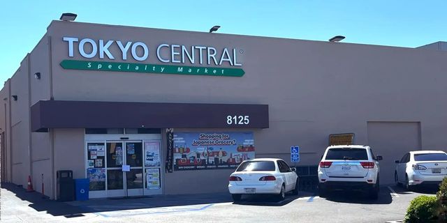 Tokyo Central Specialty Market storefront with address 8125, parking lot with white vehicles